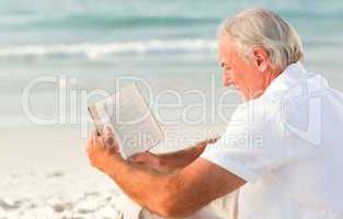 Man reading a book on the beach
