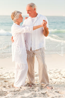 Elderly couple dancing on the beach