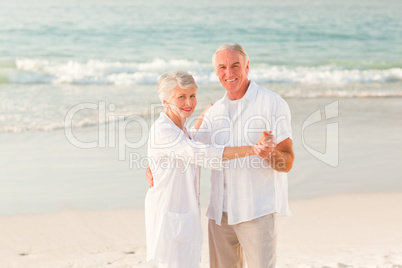 Elderly couple dancing on the beach