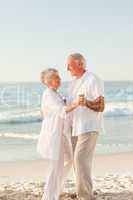 Elderly couple dancing on the beach