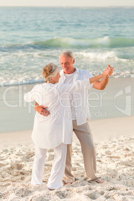 Elderly couple dancing on the beach