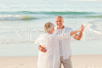 Senior couple dancing on the beach