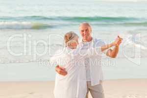 Senior couple dancing on the beach