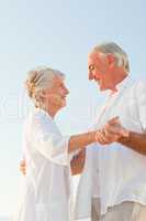 Senior couple dancing on the beach