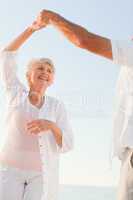 Senior couple dancing on the beach