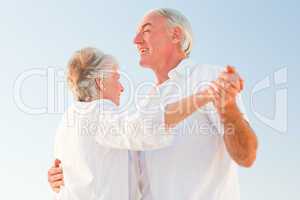 Senior couple dancing on the beach