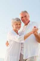 Senior couple dancing on the beach