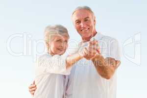 Senior couple dancing on the beach