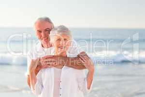 Man hugging his wife on the beach