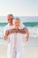 Man hugging his wife on the beach