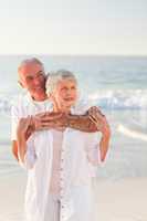 Man hugging his wife on the beach