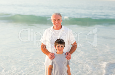 Grandfather and his grandson at the beach