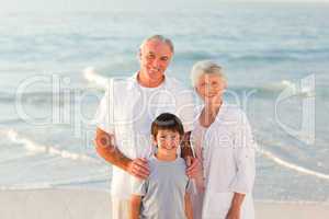 Grandparents with his grandson at the beach