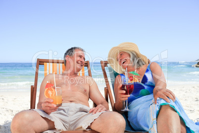 Senior couple sitting on deck chairs