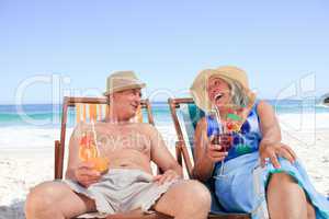 Senior couple sitting on deck chairs