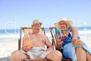 Mature couple sitting on deck chairs