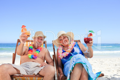 Mature couple sitting on deck chairs