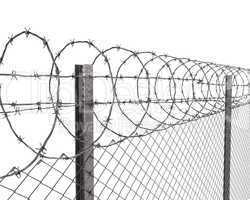 Chainlink fence with barbed wire on top closeup