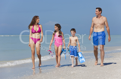 Mother, Father and Children Family Having Fun At Beach