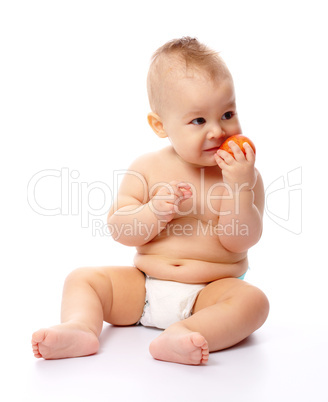 Little child is going to bite red apple