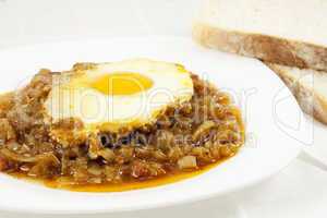 Stew with baked onion, egg and meat
