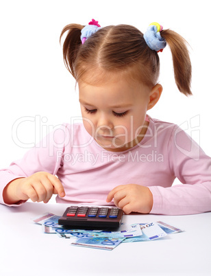 Little girl plays with money