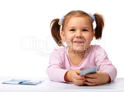 Little girl with few paper euro banknotes