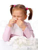 Little girl blows her nose