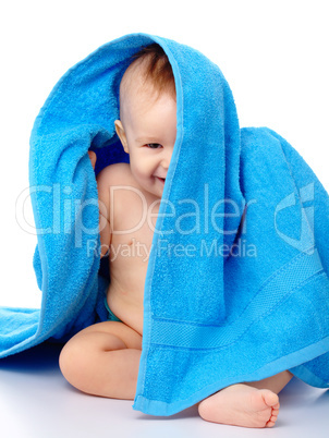 Cute child wrapped in blue towel