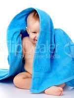 Cute child wrapped in blue towel