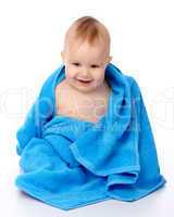 Cute child wrapped in blue towel