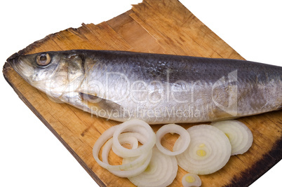Herring with onion on old wooden board