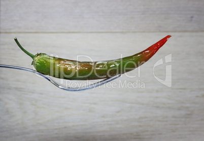 Green chili on wooden background