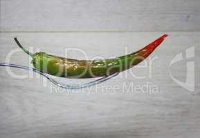 Green chili on wooden background