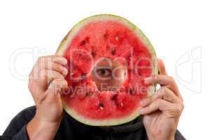 Eye looking through watermelon slice
