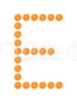 Letter "E" from orange slices isolated on white