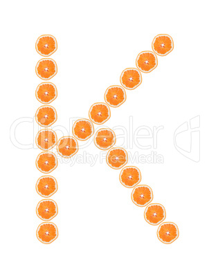 Letter "K" from orange slices isolated on white