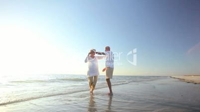 Retired Couple Dancing on the Beach