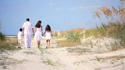 Loving Family Walking on the Beach