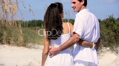 Happy Couple Walking the Beach