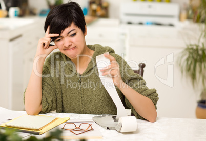 Multi-ethnic Young Woman Agonizing Over Financial Calculations