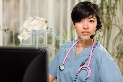 Attractive Multi-ethnic Woman Wearing Headset, Scrubs and Stetho