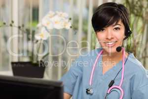 Attractive Multi-ethnic Woman Wearing Headset, Scrubs and Stetho