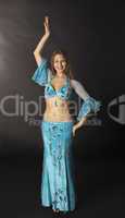 young woman dance in blue arabian costume