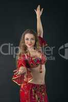 young woman dance in red arabian costume