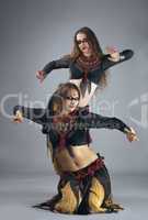 Two woman dance in warrior cosutme