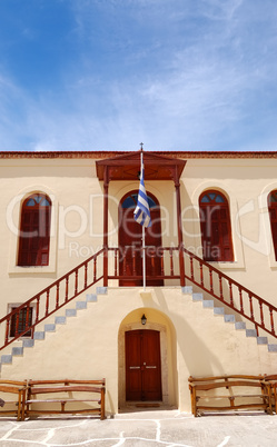 Old Greek religious building and flag, Crete, Greece