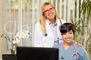 Smiling Mixed Race Female Doctors or Nurses in Office Setting