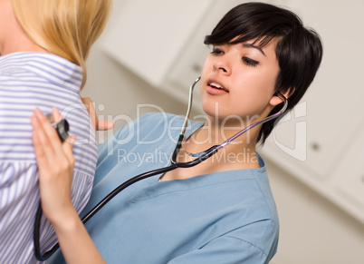 Attractive Mixed Race Young Female Doctor Using Stethoscope with