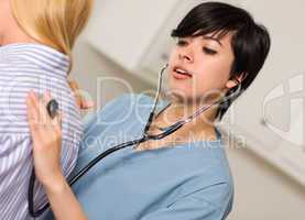 Attractive Mixed Race Young Female Doctor Using Stethoscope with
